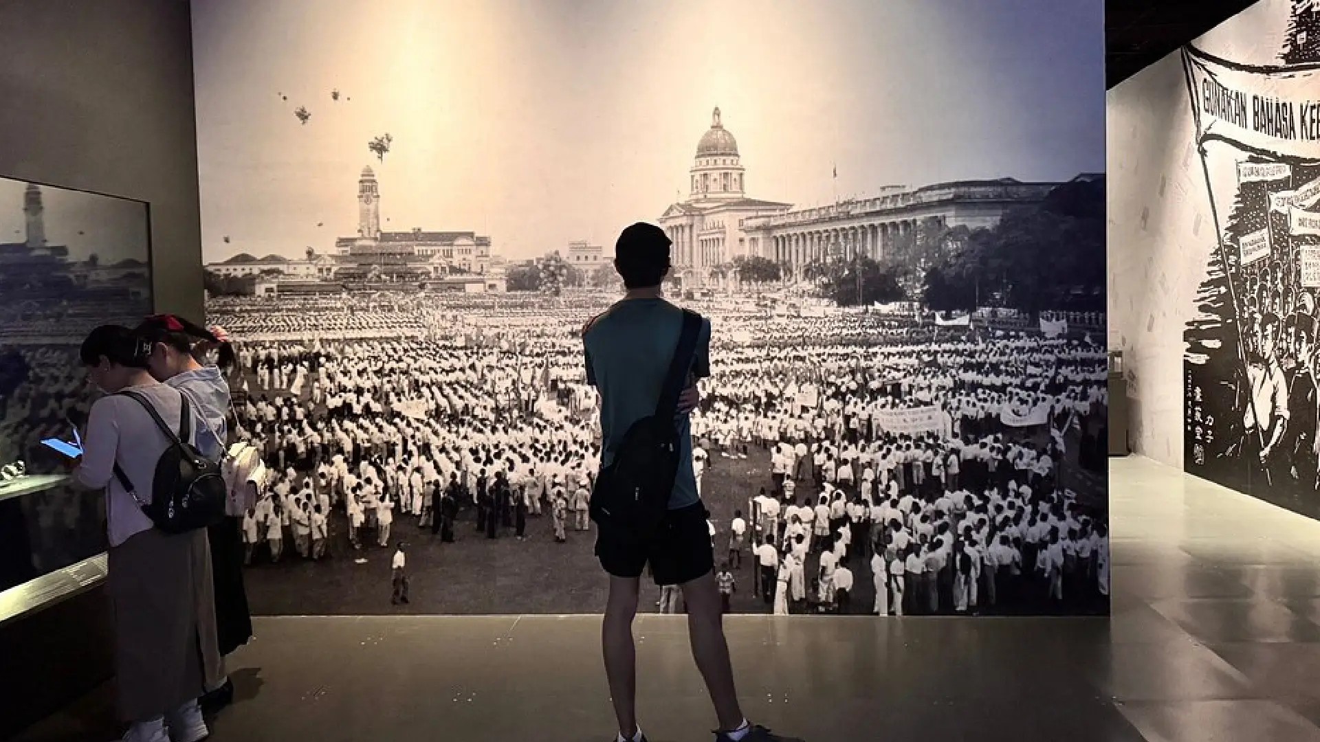 Visitors viewing a historical photo exhibit at the National Museum of Singapore.