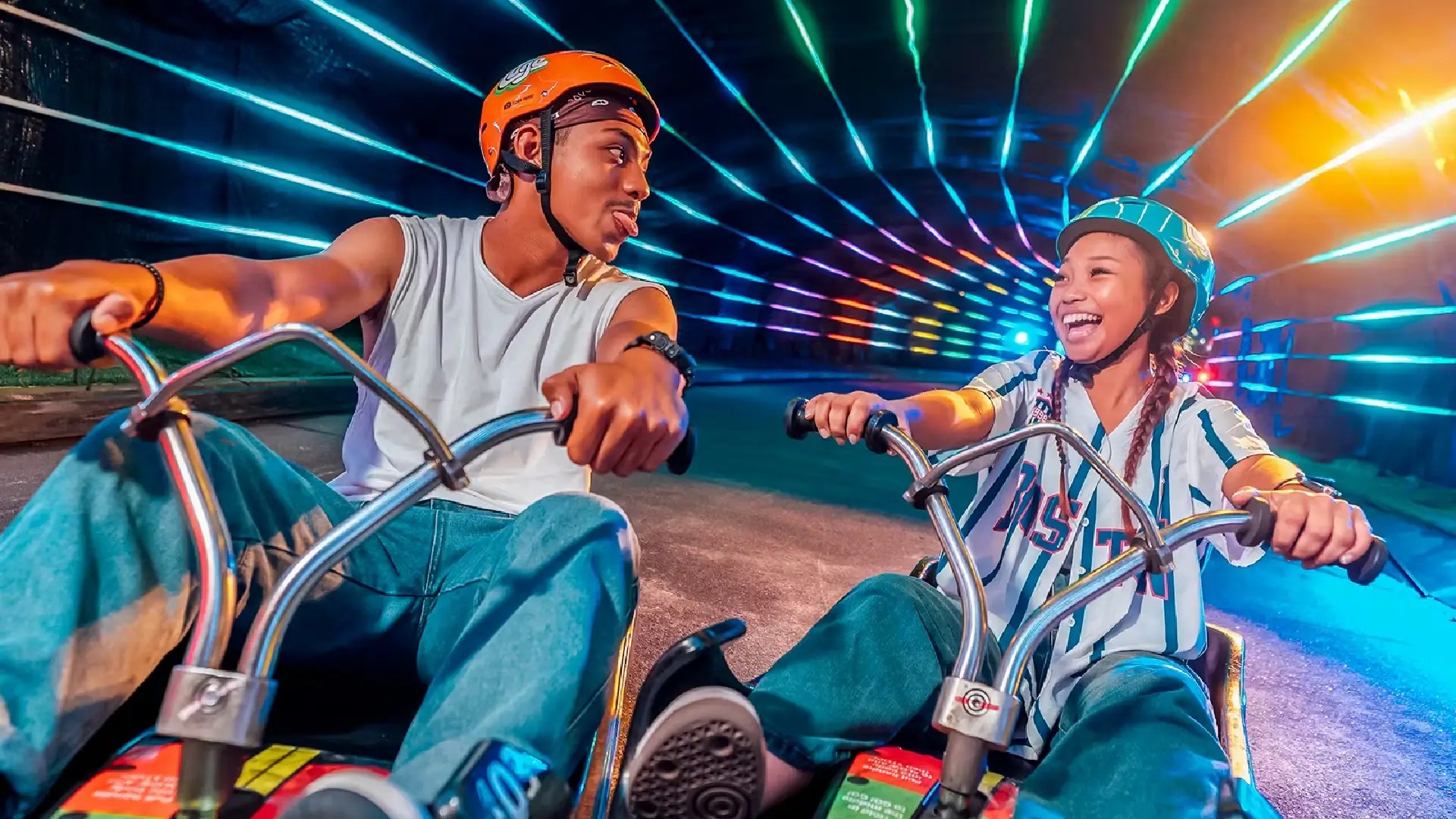 A couple riding together down the Skyline Luge track in Sentosa, enjoying a fun outdoor activity for couples in Singapore.