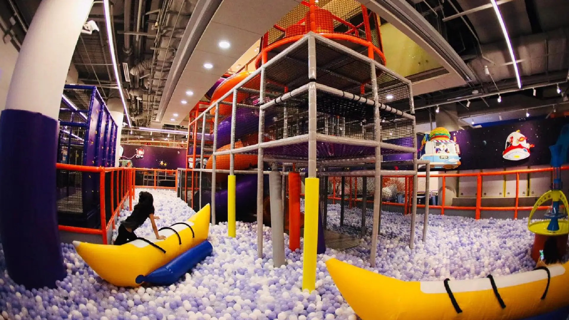 Space-themed play zone at Kiztopia Singapore, featuring a giant ball pit, climbing structures, and inflatable obstacles for kids.