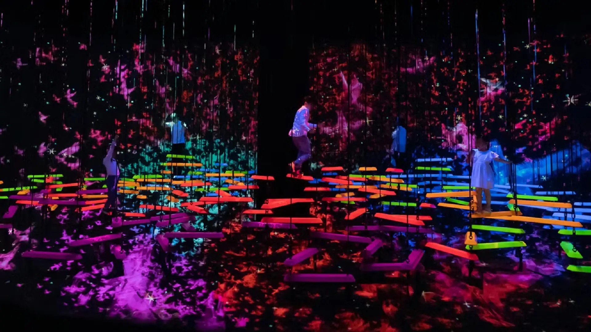 Children exploring colourful interactive digital installations at the ArtScience Museum’s Future World exhibit in Singapore.