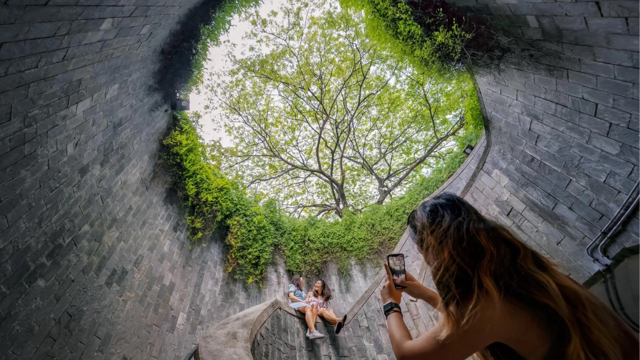 Visitors posing at Fort Canning Tree Tunnel in Singapore, a popular spot for sightseeing, photos and fun city activities.