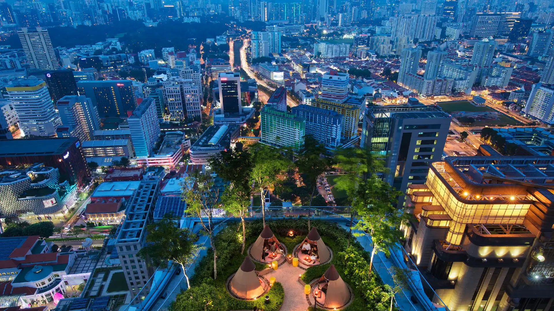 Mr Stork rooftop bar at Andaz Singapore with teepee lounges and sweeping city skyline views at night.