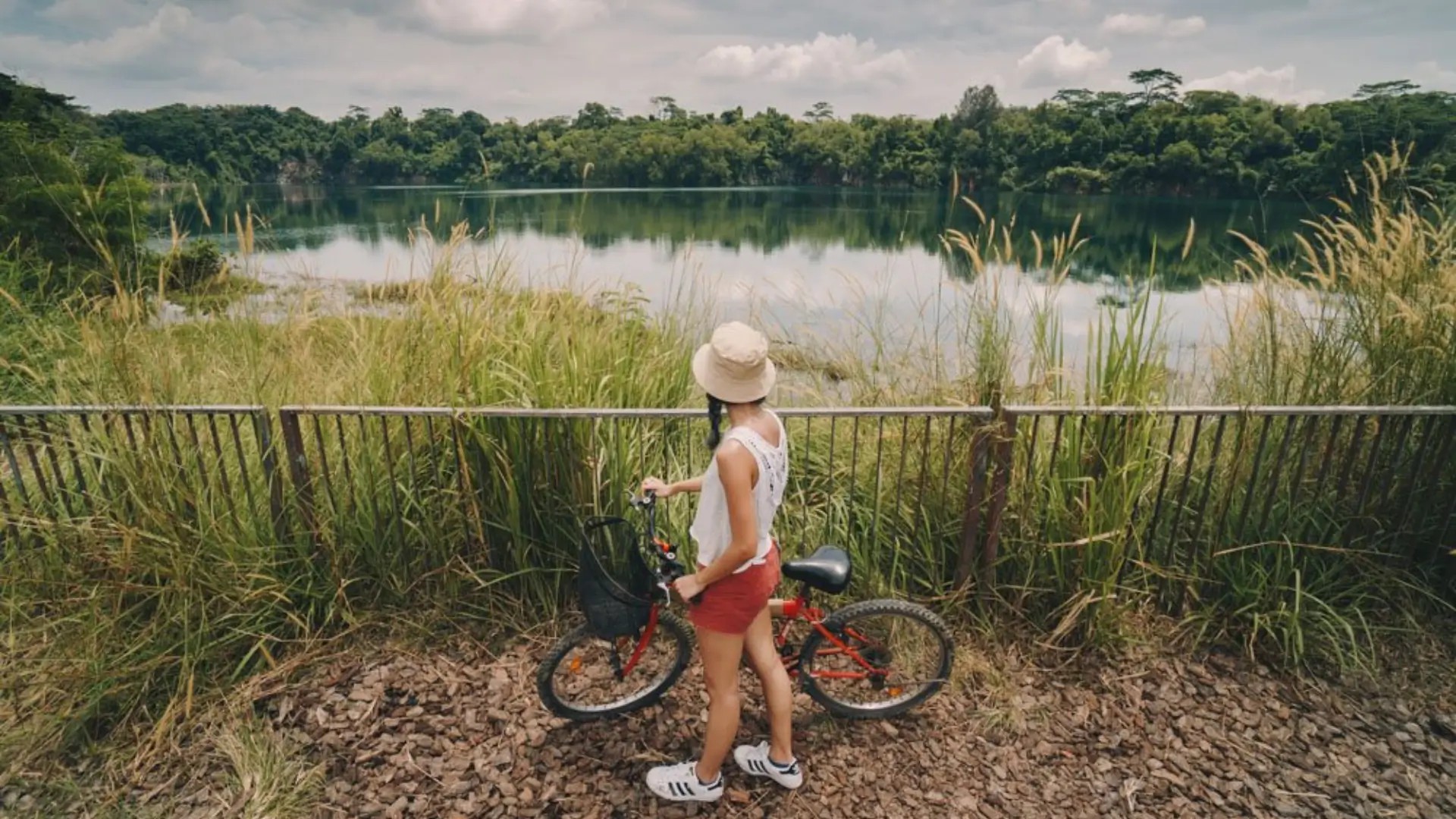 Cyclist stopping by Ketam Quarry on Pulau Ubin, enjoying scenic cycling trails and Singapore’s rustic island landscape.