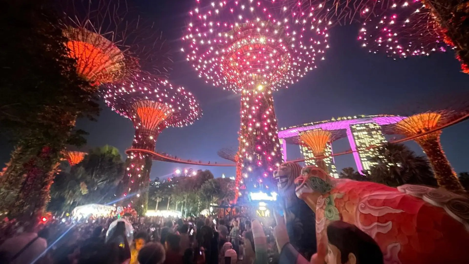 Garden Rhapsody light show at Gardens by the Bay with illuminated Supertrees glowing in sync with music at night in Singapore