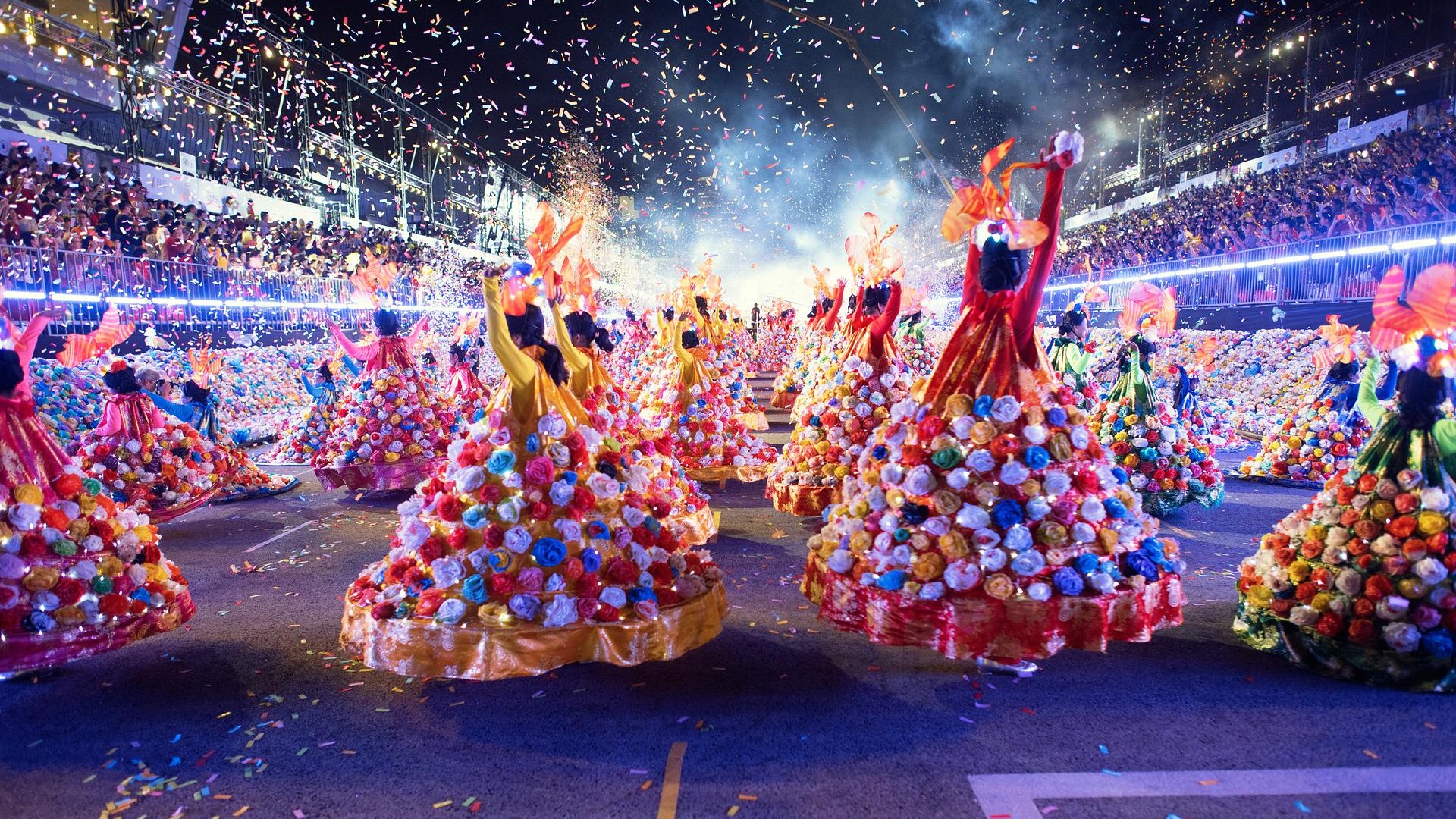 Chingay Parade performers in colourful costumes during a night festival in Singapore