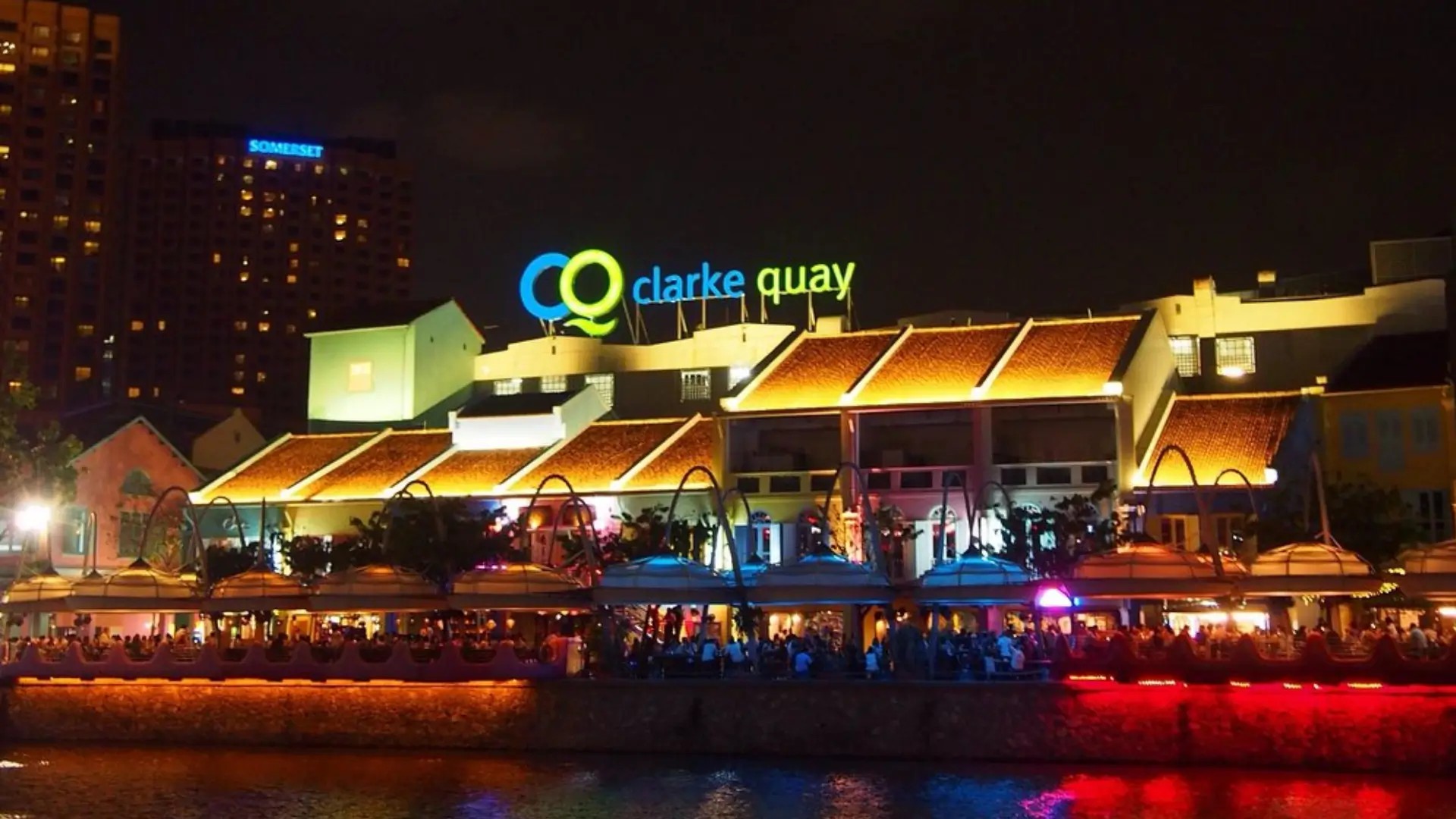 Clarke Quay riverfront at night with illuminated buildings and lively nightlife in Singapore