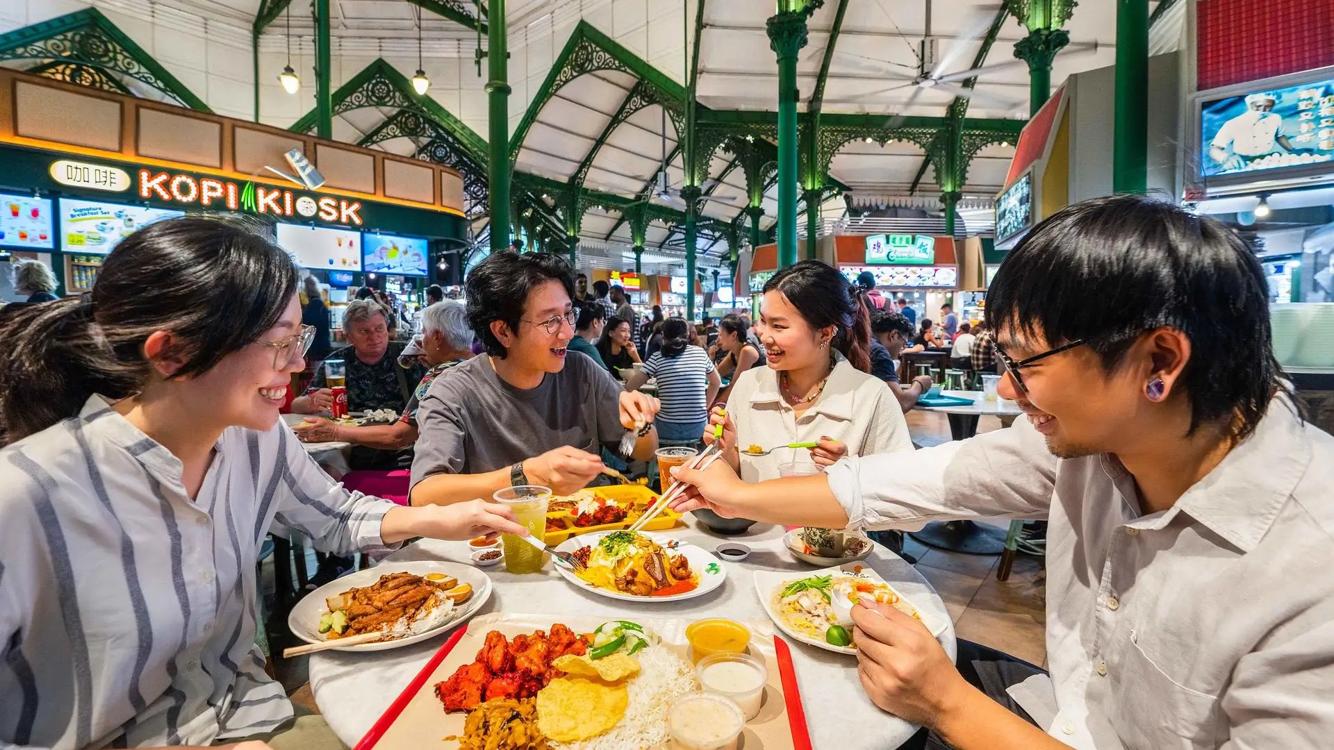 People enjoying hawker food at Lau Pa Sat, Singapore’s historic food hall with satay stalls and lively dining atmosphere.