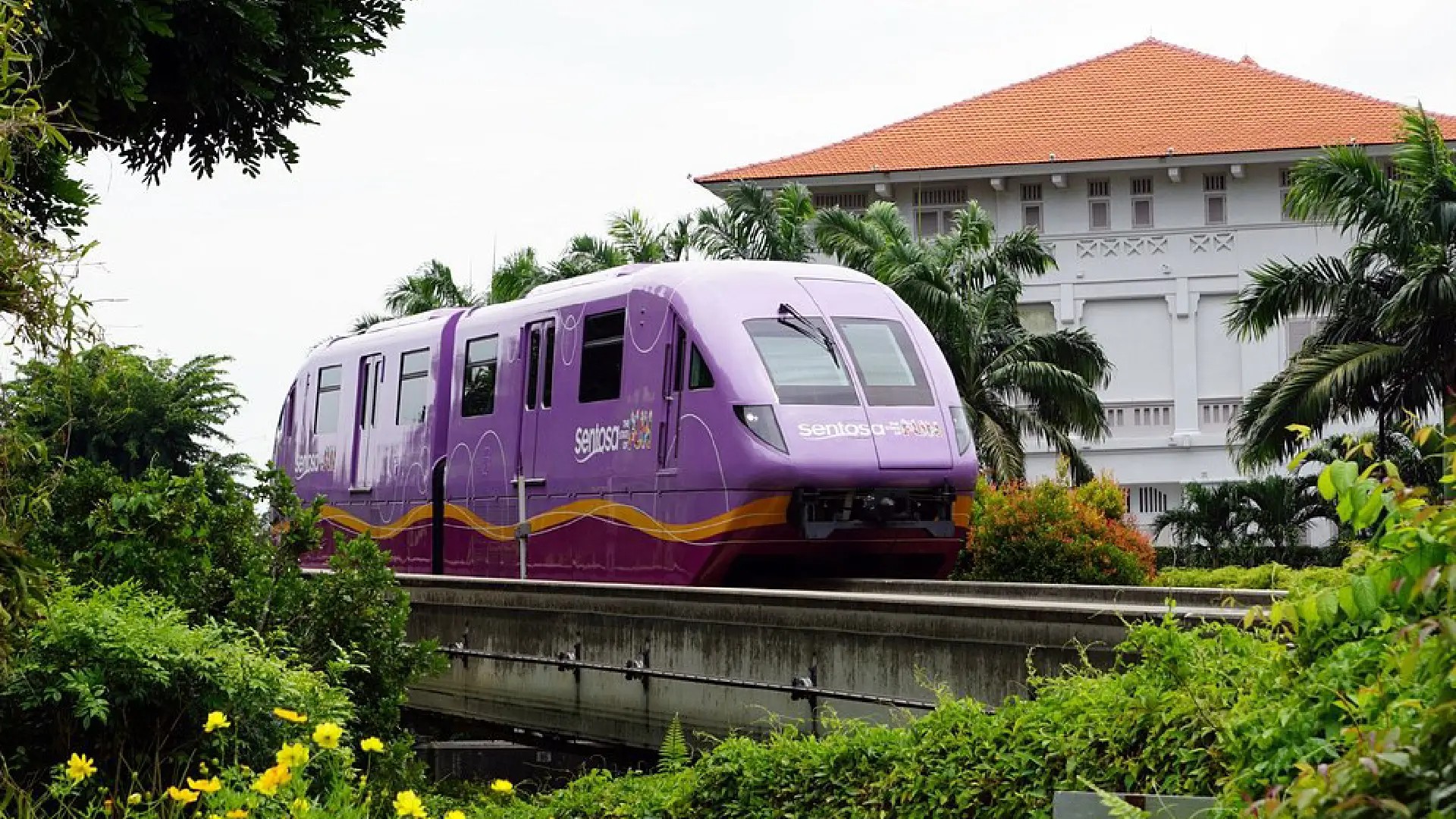 Sentosa Express monorail crossing greenery, transporting visitors between Sentosa Island and mainland Singapore.