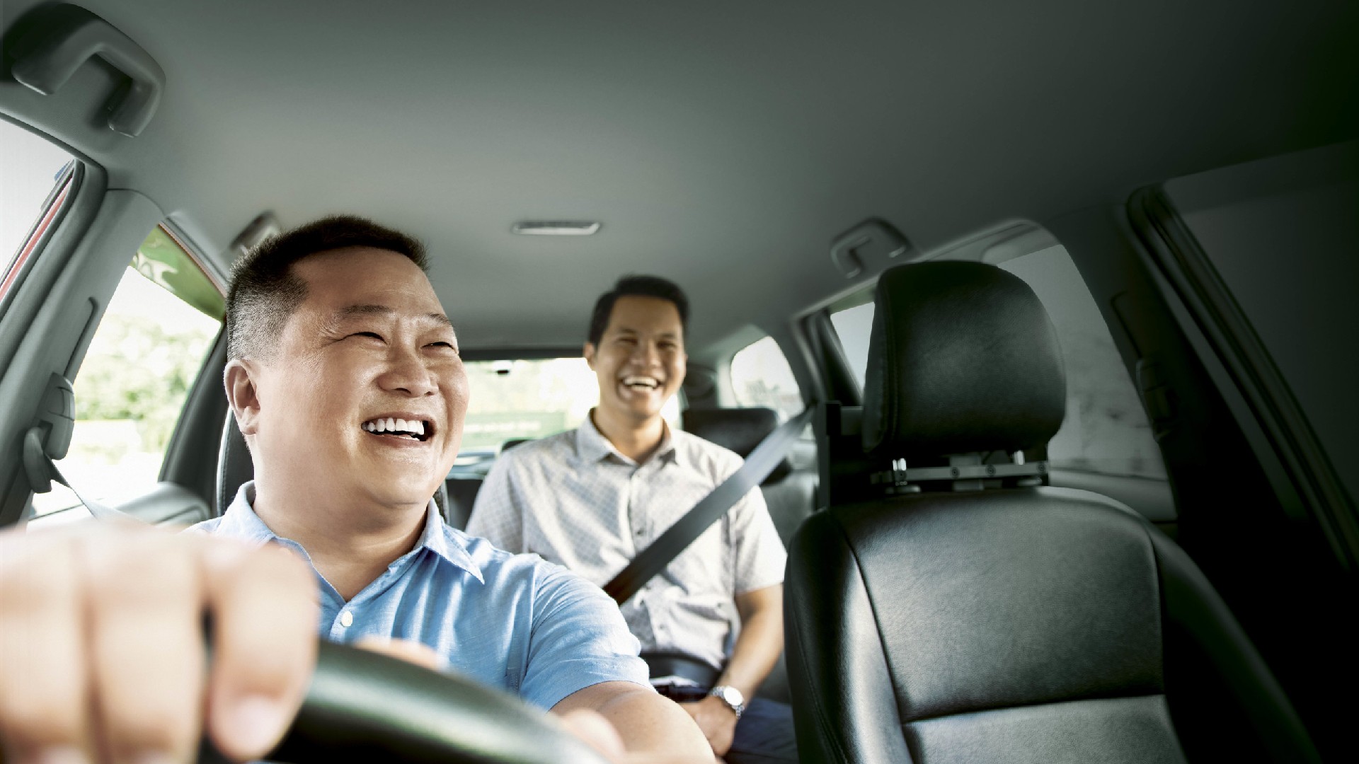 Passengers enjoying a taxi or Grab ride travelling by car to Sentosa Island in Singapore