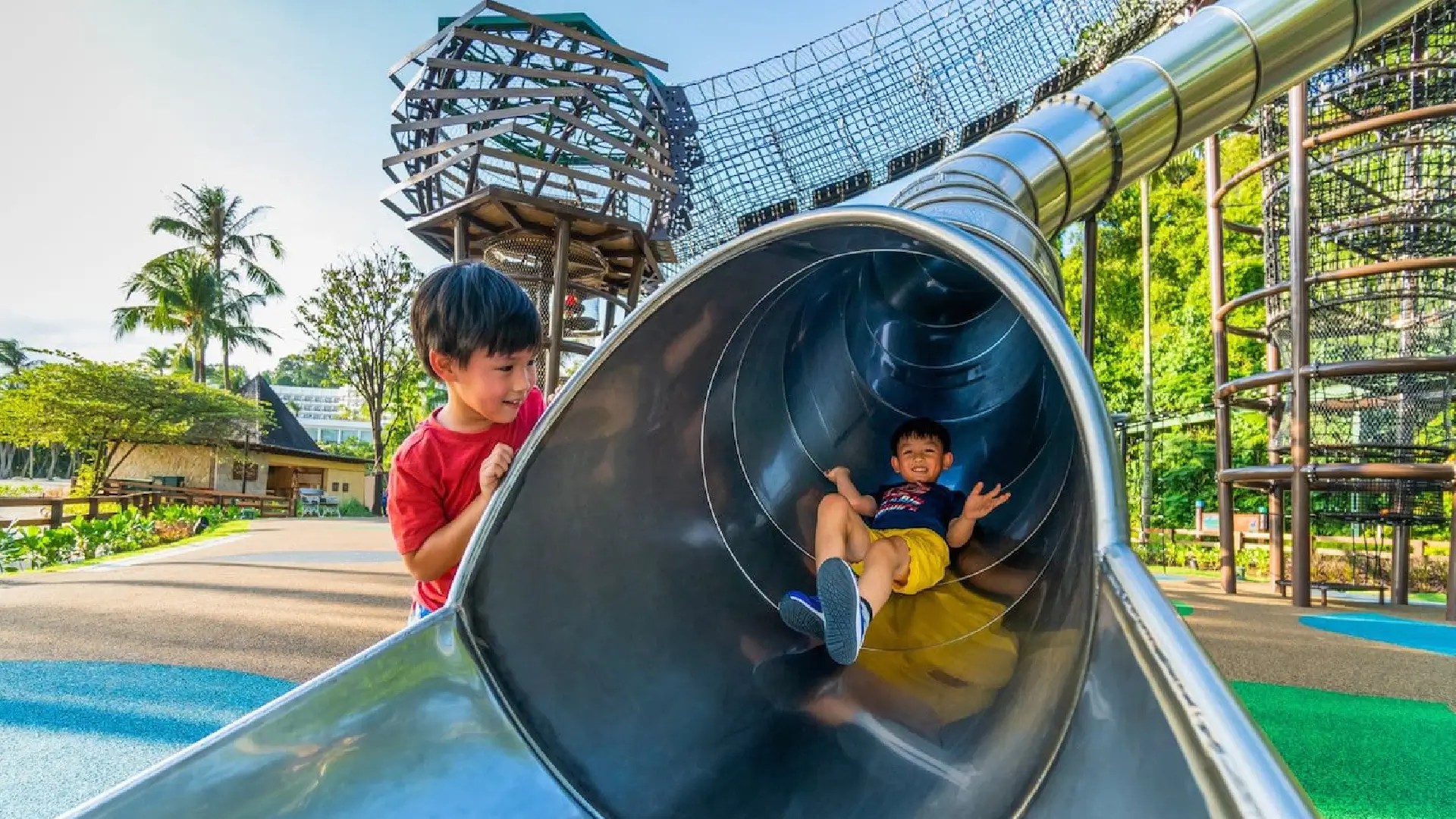 Children playing on a playground slide at Sentosa Island, a family-friendly attraction in Singapore