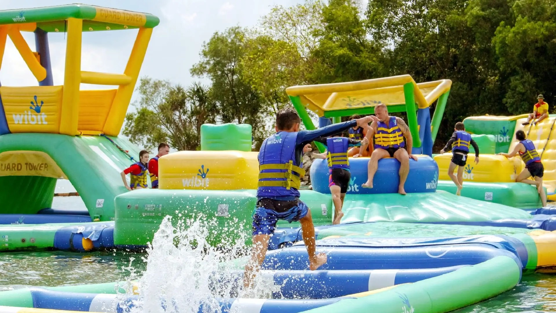 Visitors enjoying the HydroDash inflatable obstacle course at Palawan Beach on Sentosa Island