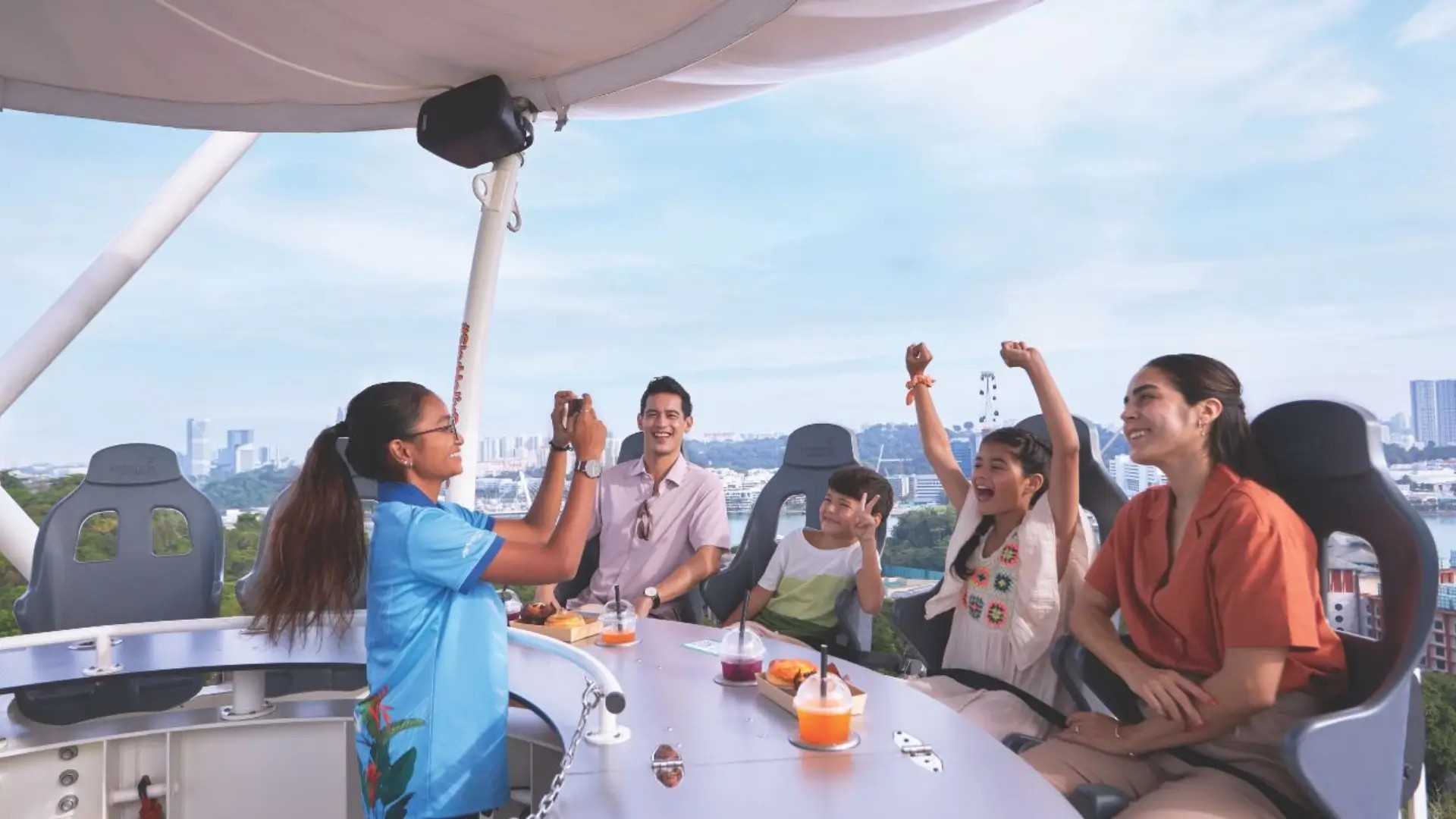 Family enjoying SkyHelix Sentosa, Singapore’s highest open-air panoramic ride with skyline and harbour views.