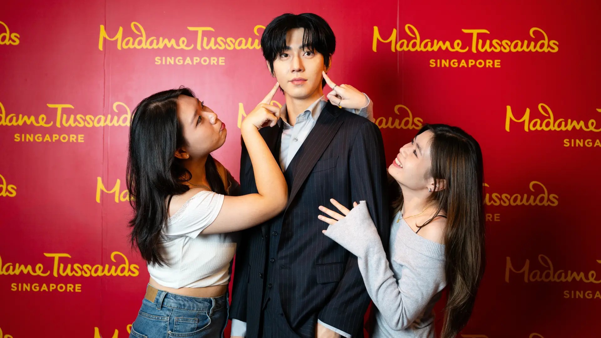 Visitors posing with wax figures at Madame Tussauds Singapore, a popular photo stop near Sentosa Sensoryscape