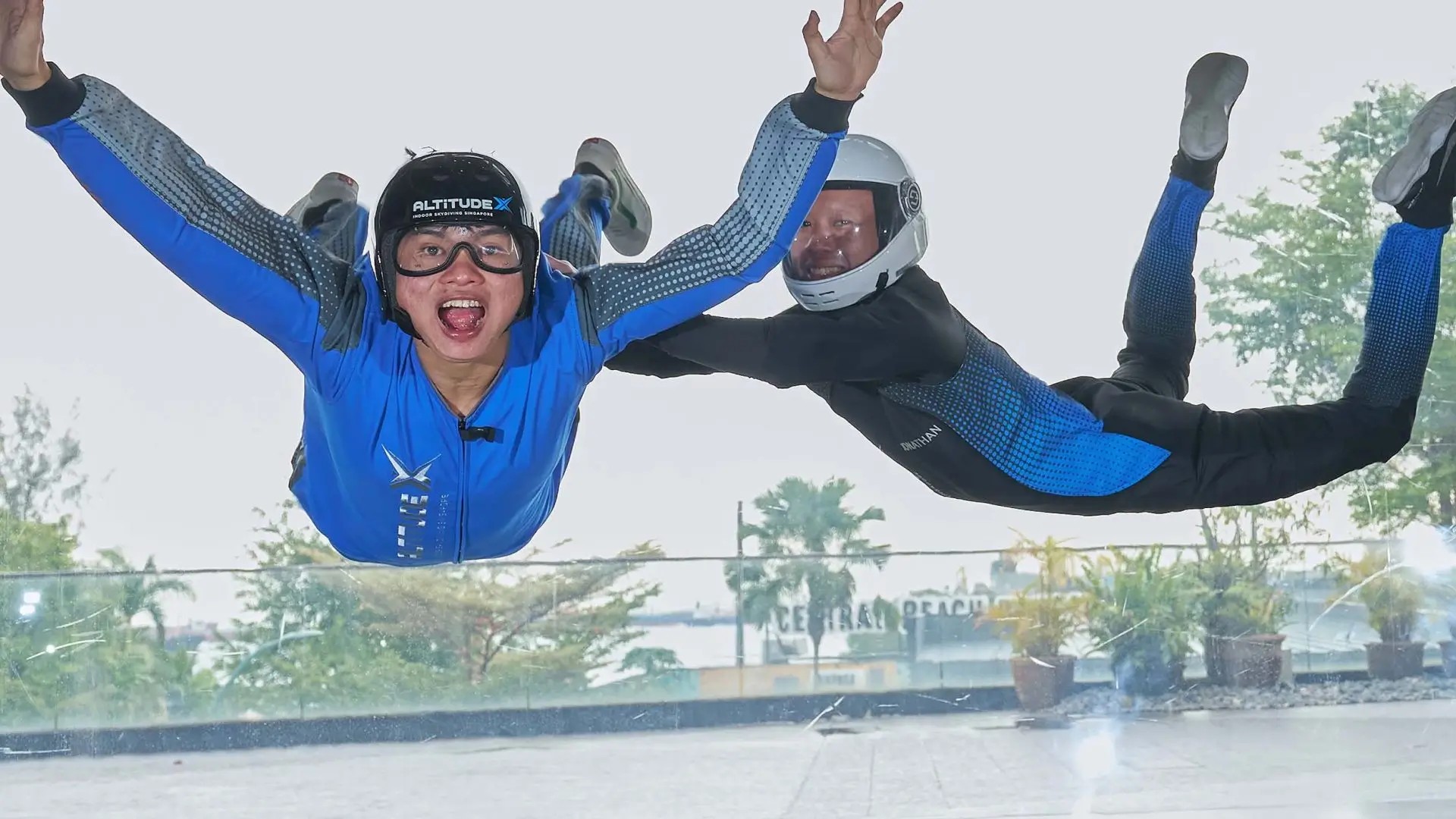 Participants flying in an indoor wind tunnel during the AltitudeX Singapore skydiving experience