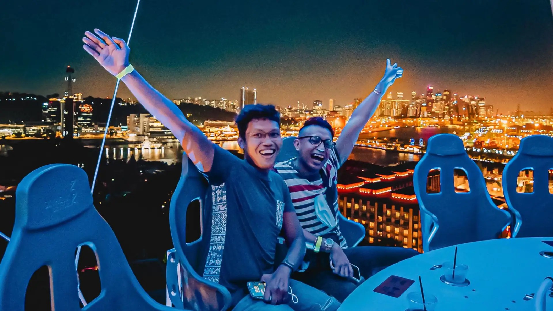 Visitors enjoying panoramic night views of Singapore from the SkyHelix Sentosa open-air ride