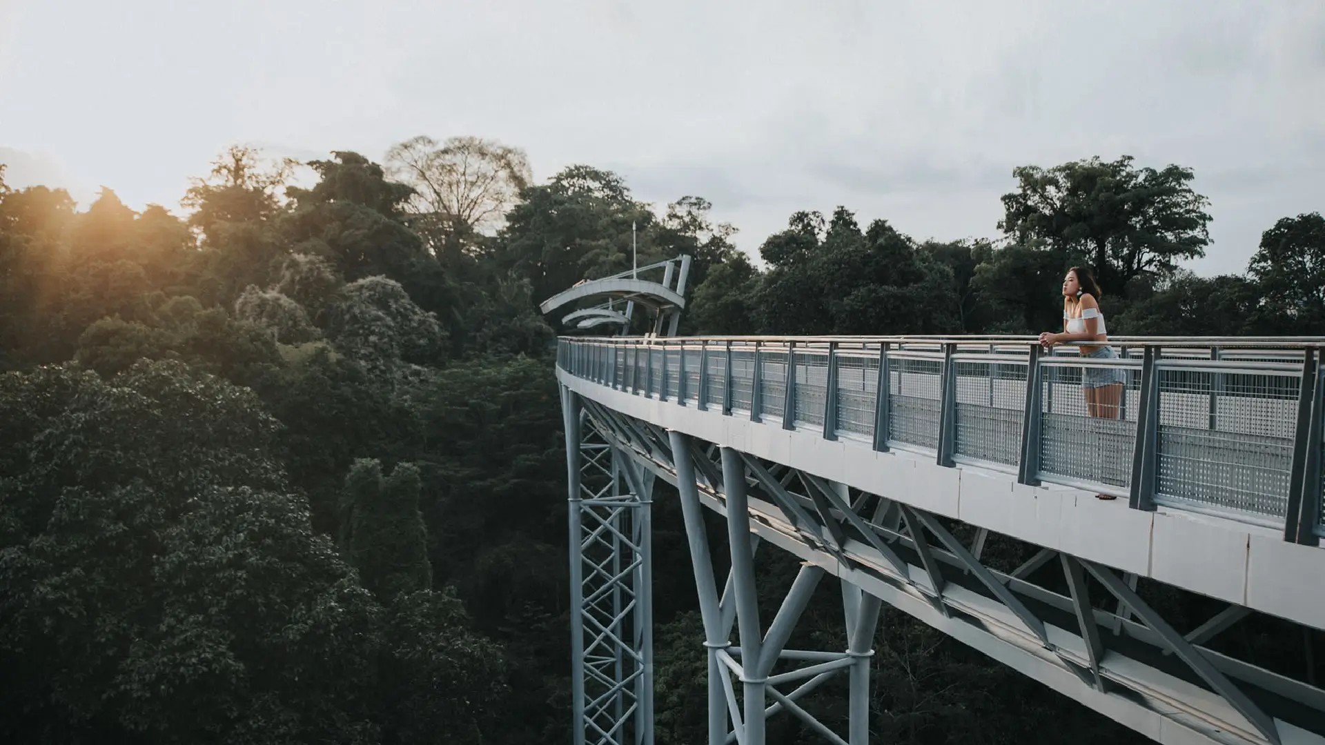 Visitor walking along Fort Siloso Skywalk, an elevated walkway above the forest on Sentosa Island