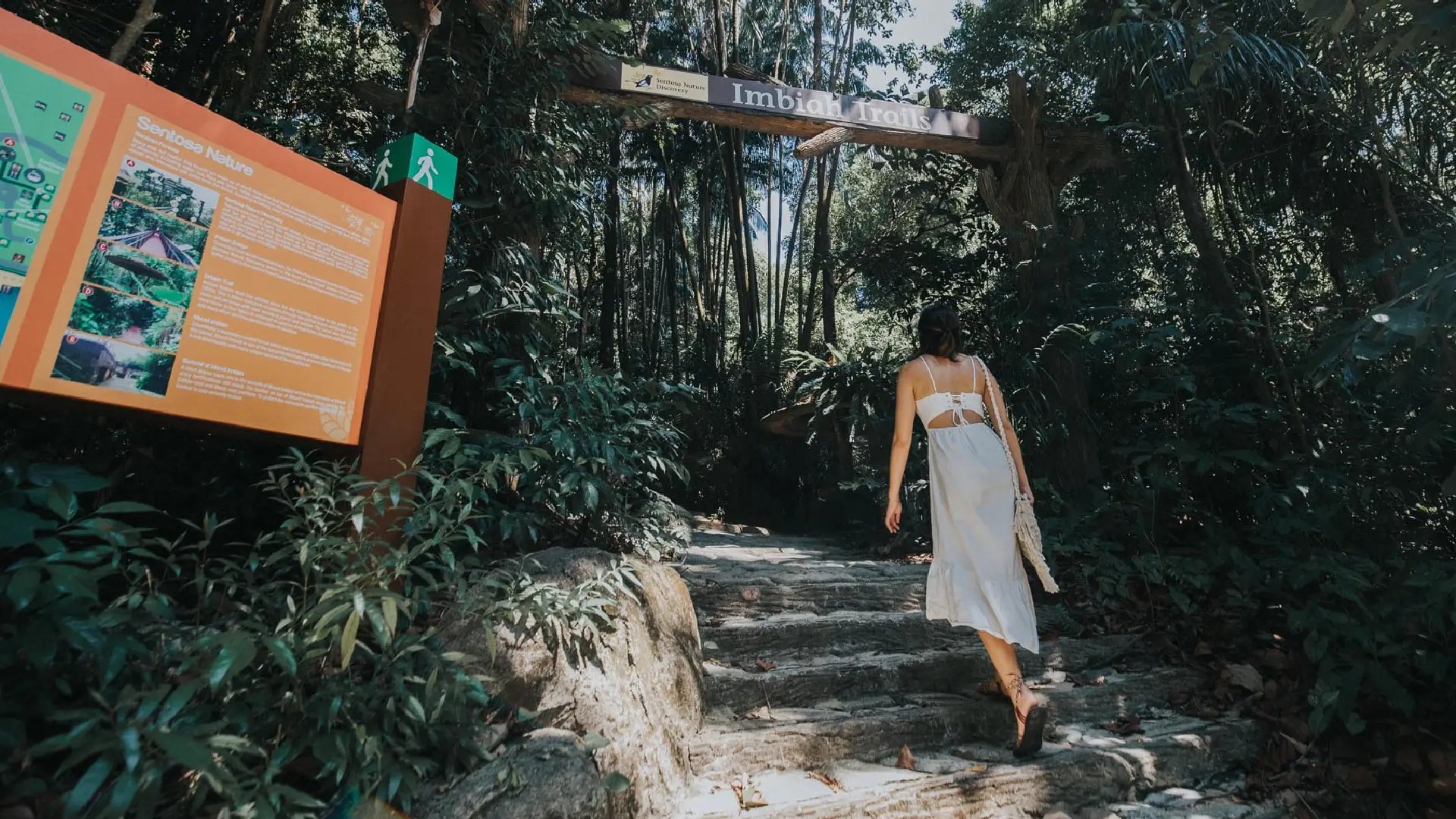 Visitor walking along the Imbiah Trails, a shaded forest nature walk on Sentosa Island