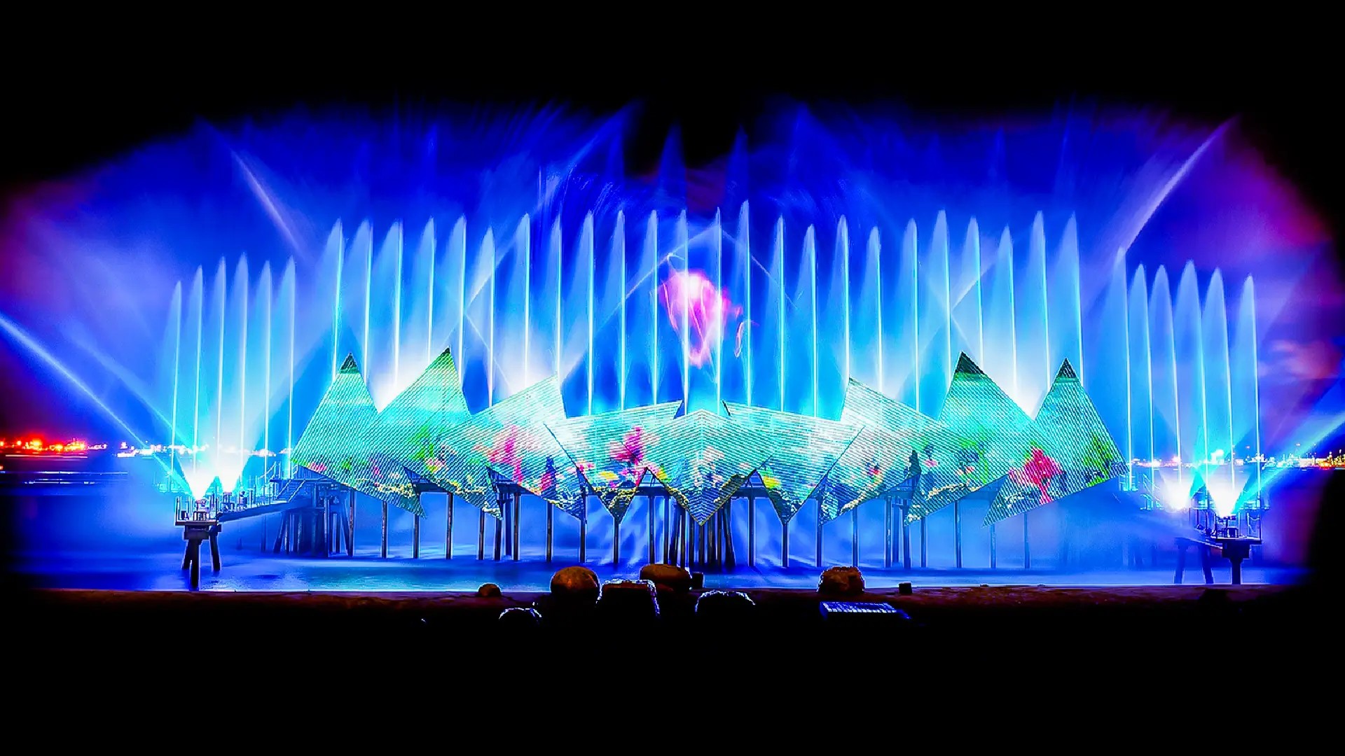Wings of Time nighttime show at Sentosa featuring illuminated water jets, lasers, and pyrotechnics over the sea