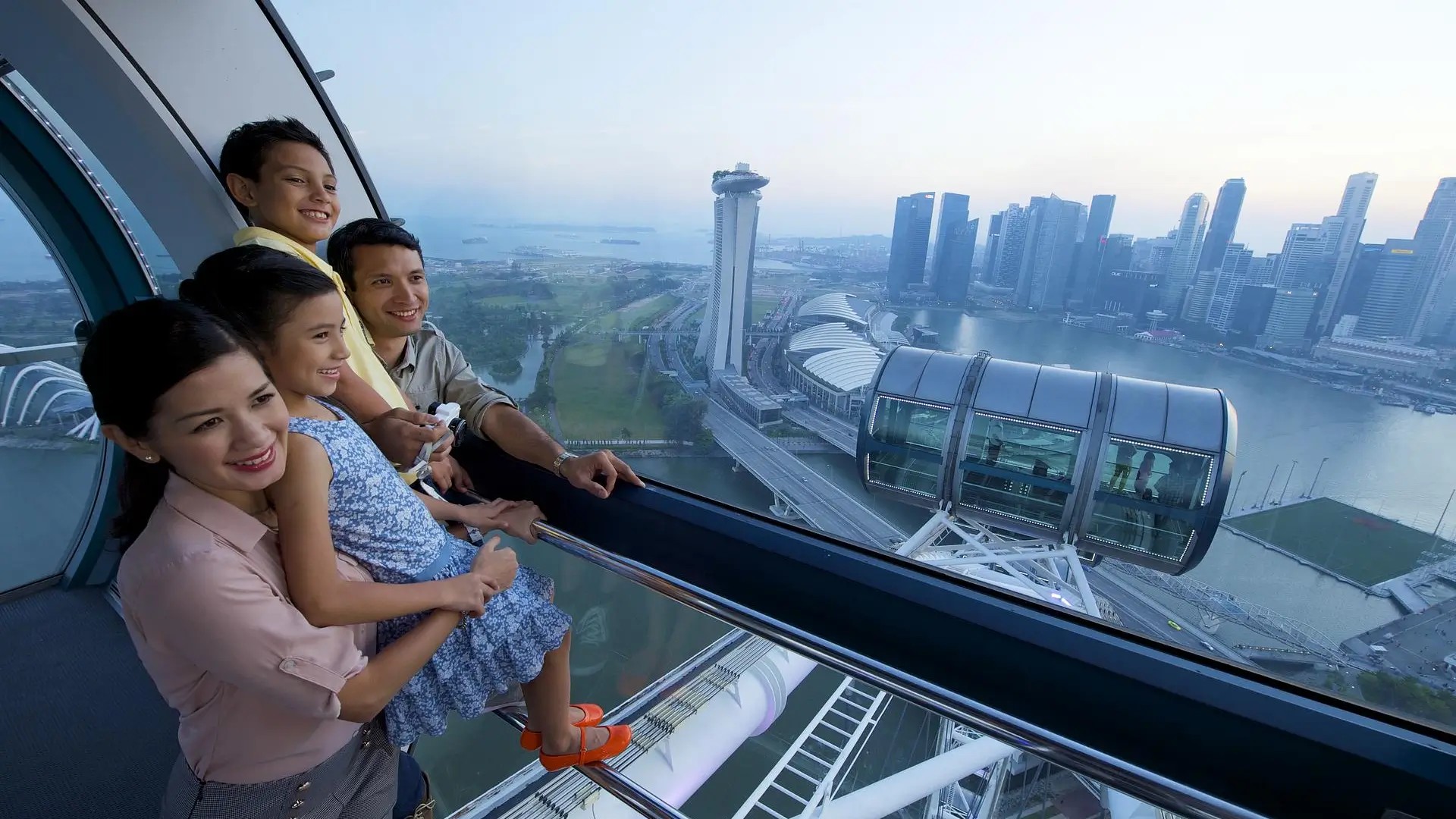 Family enjoying panoramic views from the Singapore Flyer overlooking Marina Bay