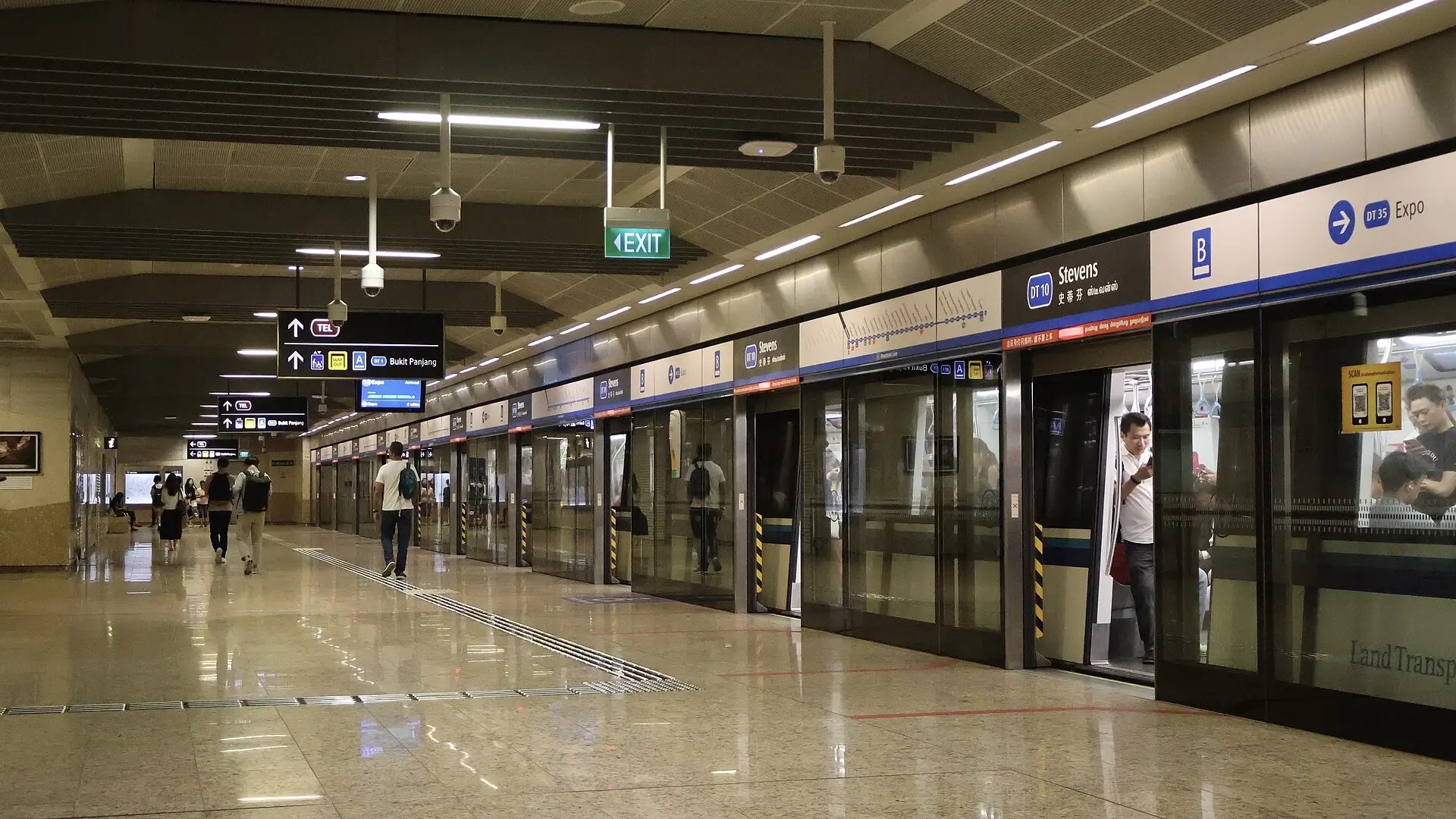 Passengers boarding a train at a Singapore MRT station platform