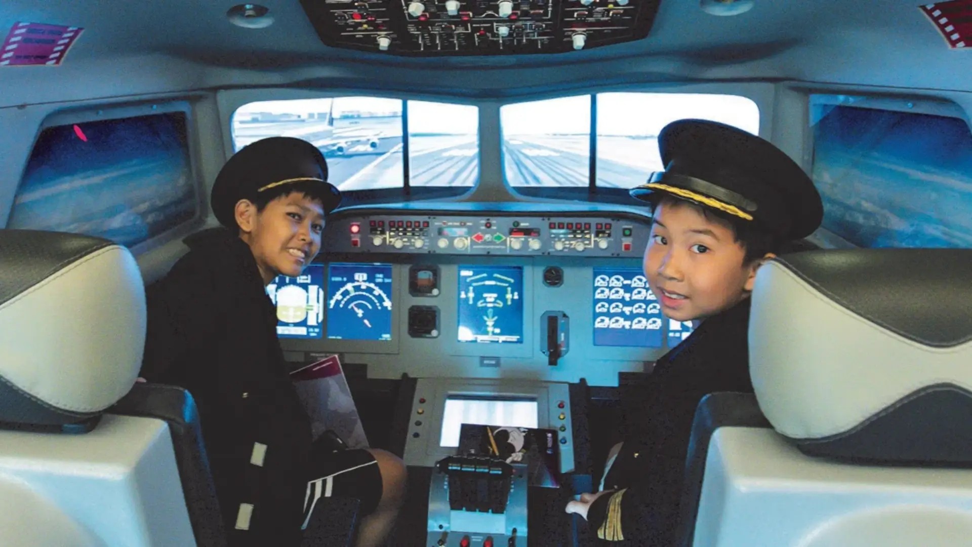Children taking part in a pilot cockpit experience at KidZania Singapore.